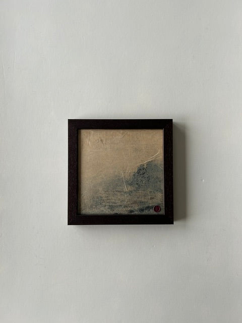 Framed abstract landscape artwork, inspired by japanese ink art, created with ink, charcoal and paper techniques. Encased in a walnut-style frame with a red wax stamp signature, blending traditional craftmanship with modern aesthetics