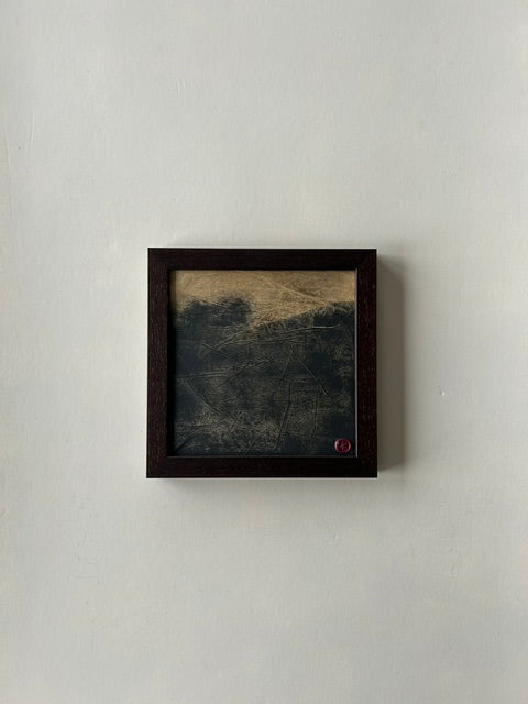 Framed abstract landscape artwork, inspired by japanese ink art, created with ink, charcoal and paper techniques. Encased in a walnut-style frame with a red wax stamp signature, blending traditional craftmanship with modern aesthetics