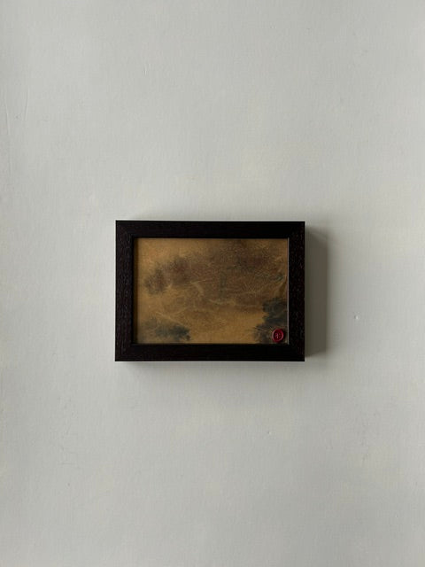 Framed abstract landscape artwork, inspired by japanese ink art, created with ink, charcoal and paper techniques. Encased in a walnut-style frame with a red wax stamp signature, blending traditional craftmanship with modern aesthetics