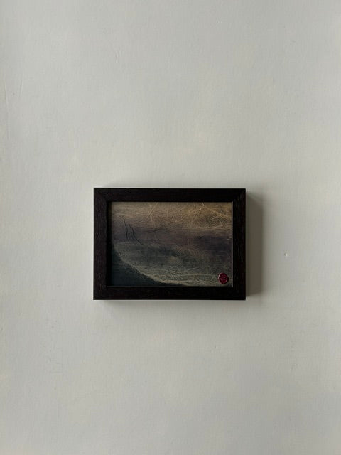 Framed abstract landscape artwork, inspired by japanese ink art, created with ink, charcoal and paper techniques. Encased in a walnut-style frame with a red wax stamp signature, blending traditional craftmanship with modern aesthetics