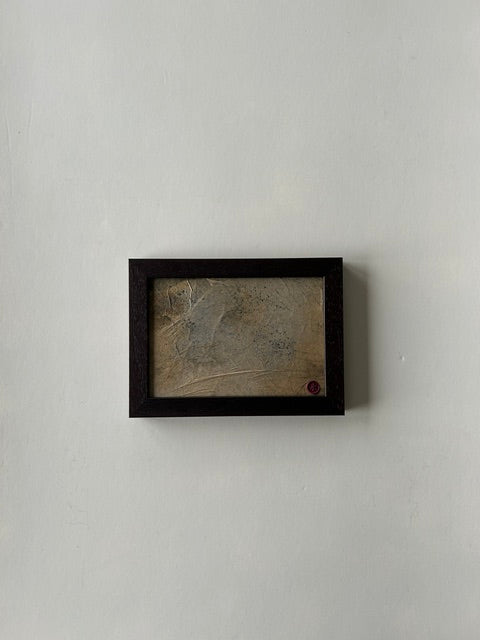 Framed abstract landscape artwork, inspired by japanese ink art, created with ink, charcoal and paper techniques. Encased in a walnut-style frame with a red wax stamp signature, blending traditional craftmanship with modern aesthetics